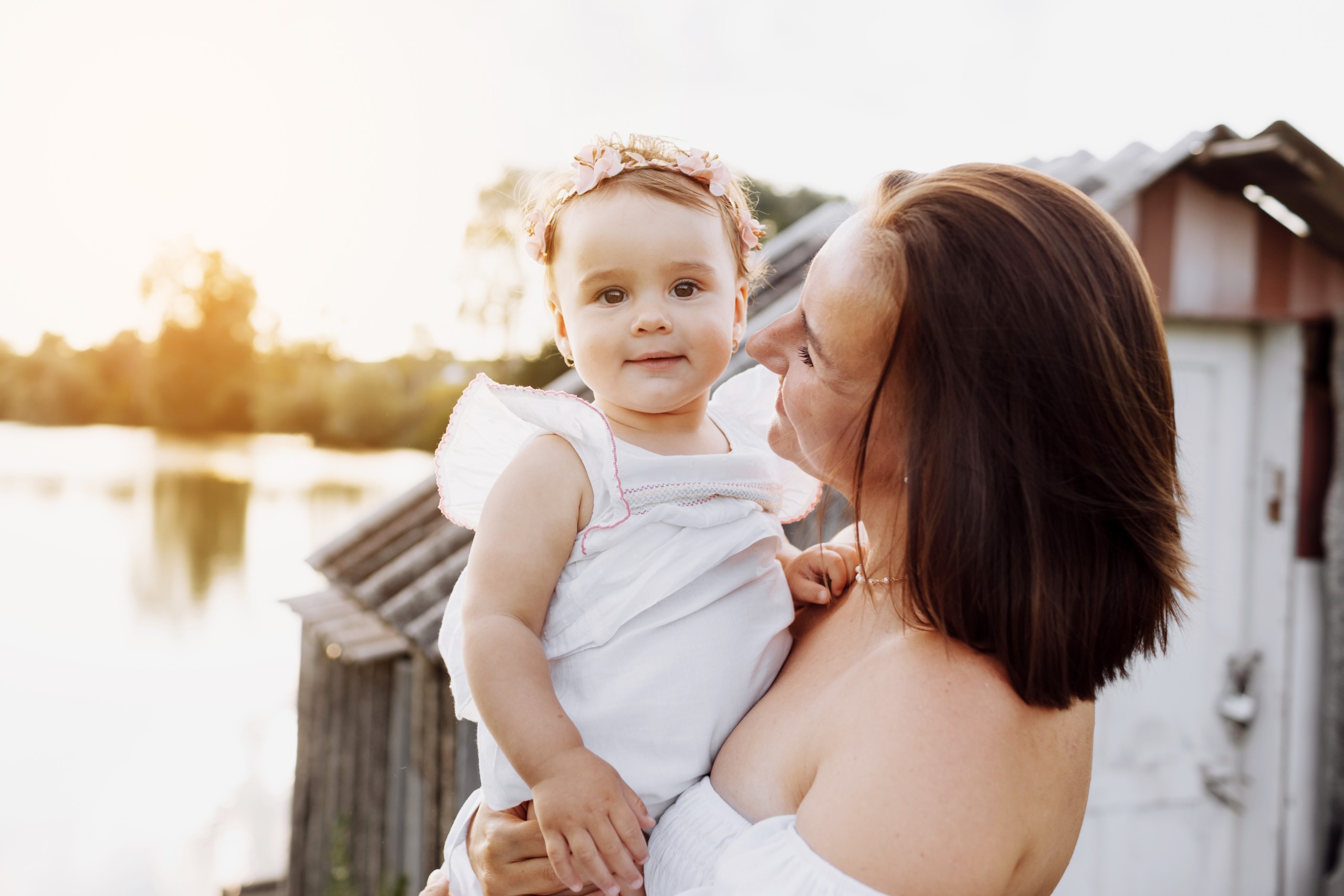 young mom kissing her baby girl